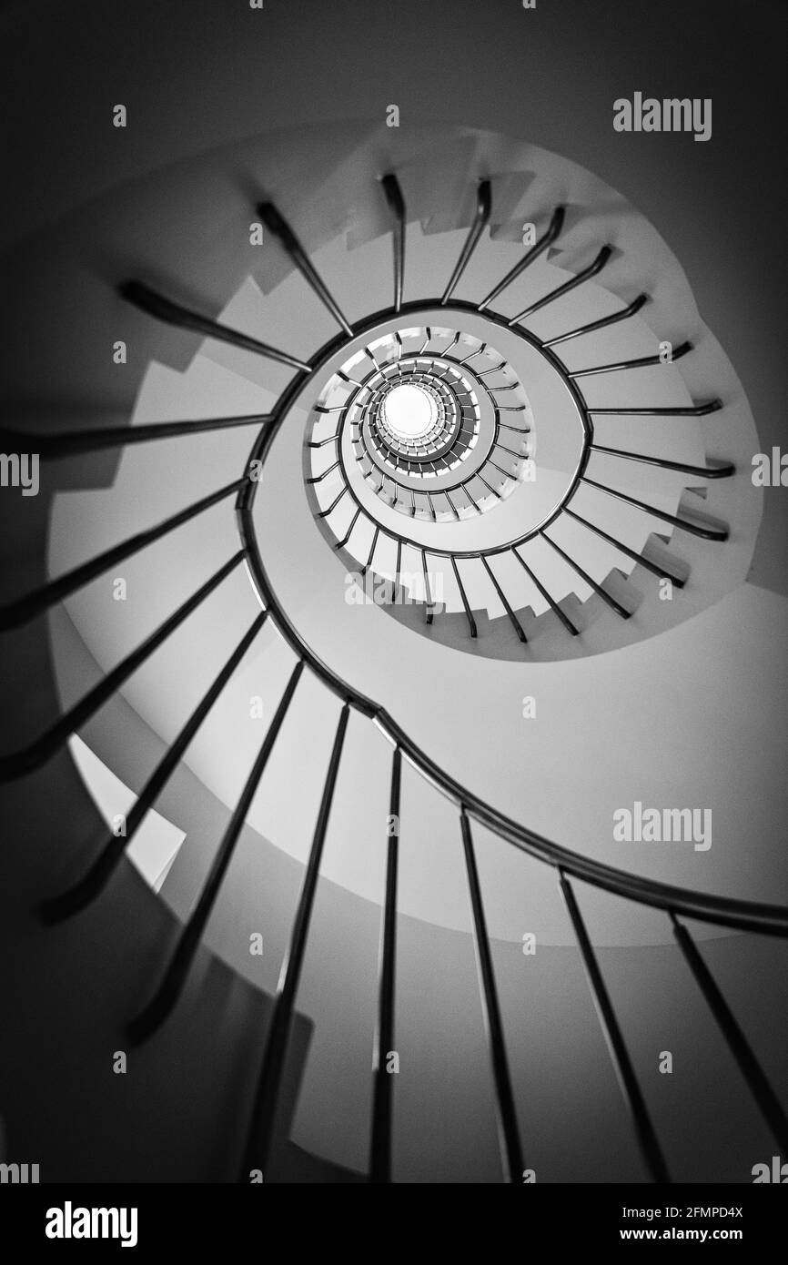 Low angle grayscale shot of the spiral staircase Stock Photo