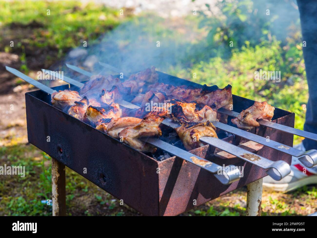 Burnt chicken kebab on the grill Stock Photo