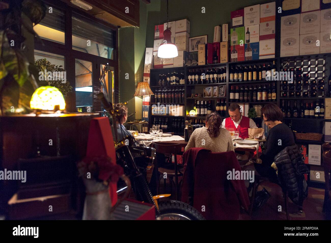 Interiors of the Restaurant Damm atra located in Milano, during a typical working evening while customers eat and drink at the tables, Milan, Italy, L Stock Photo
