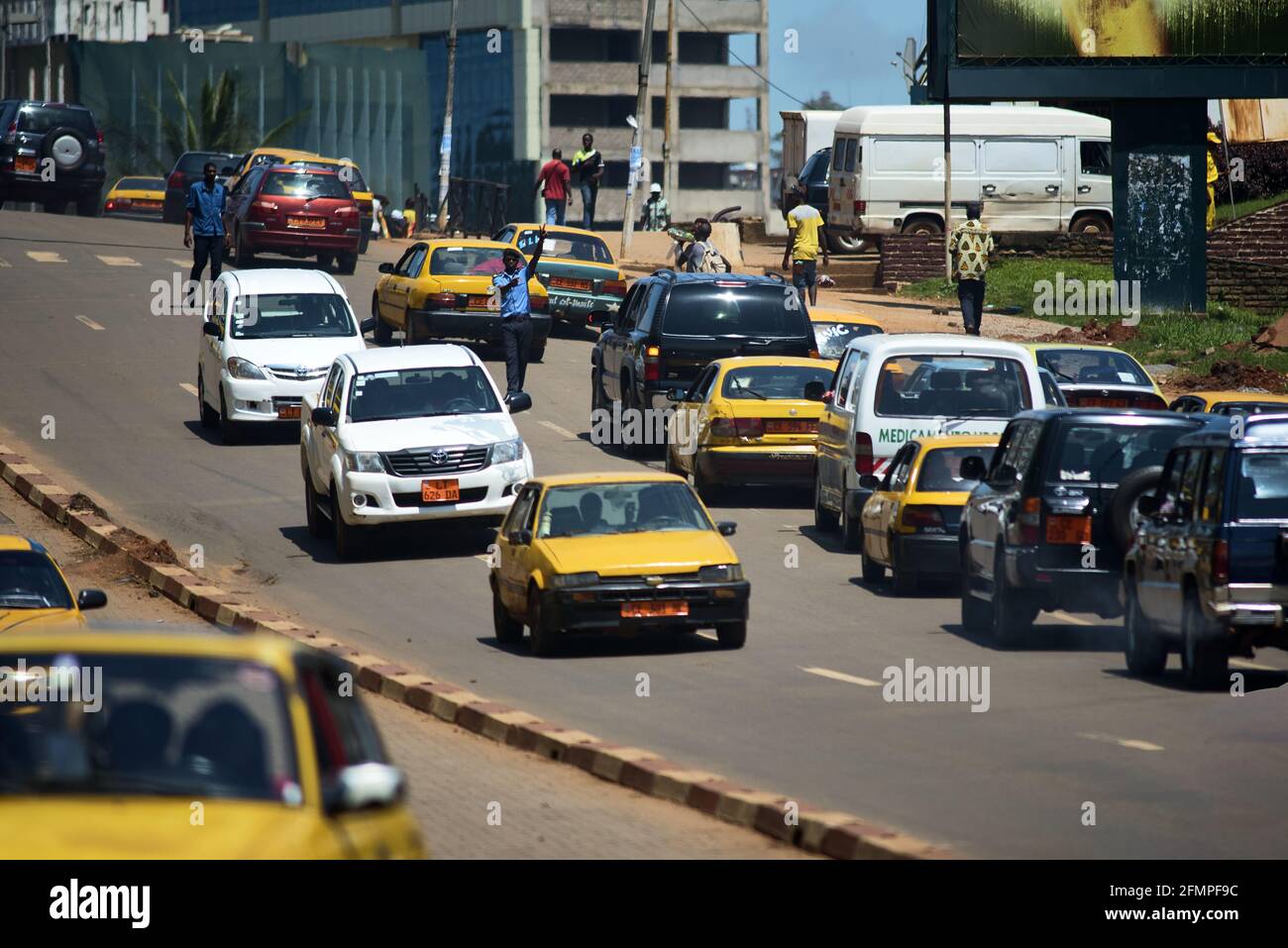 Policeman directing the traffic in the rush hour of Yaounde Stock Photo