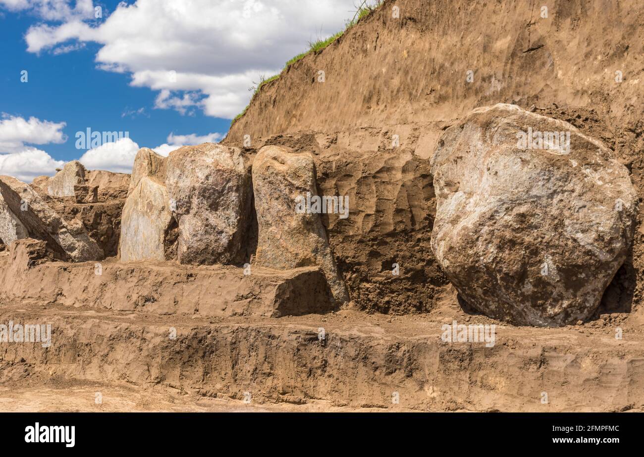Excavations place of granite gravestone plates in ancient burial mound in Novooleksandrivka village in Ukraine dated circa 1200s BC Stock Photo