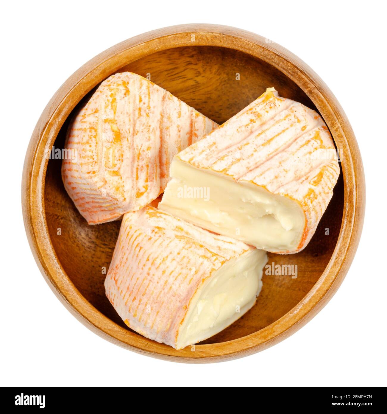 French soft cheese triangles, in a wooden bowl. Saint Albray, a cheese from the Aquitaine region of France, similar to Camembert. Stock Photo