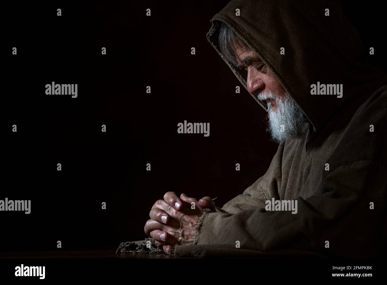 A medieval monk in prayer Stock Photo