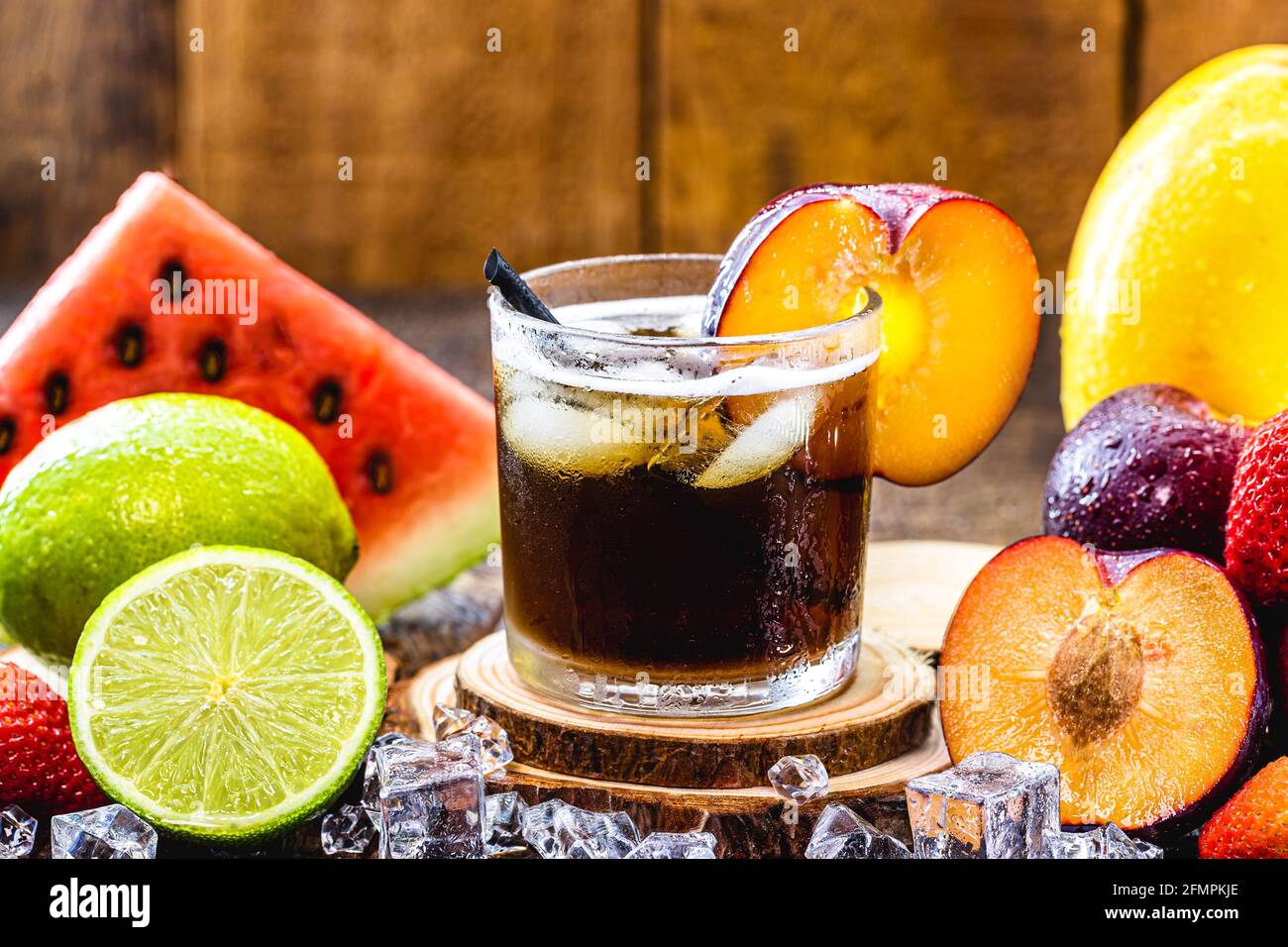 glass of typical Brazilian drink called caipirinha, plum flavor, made with fruits, distilled