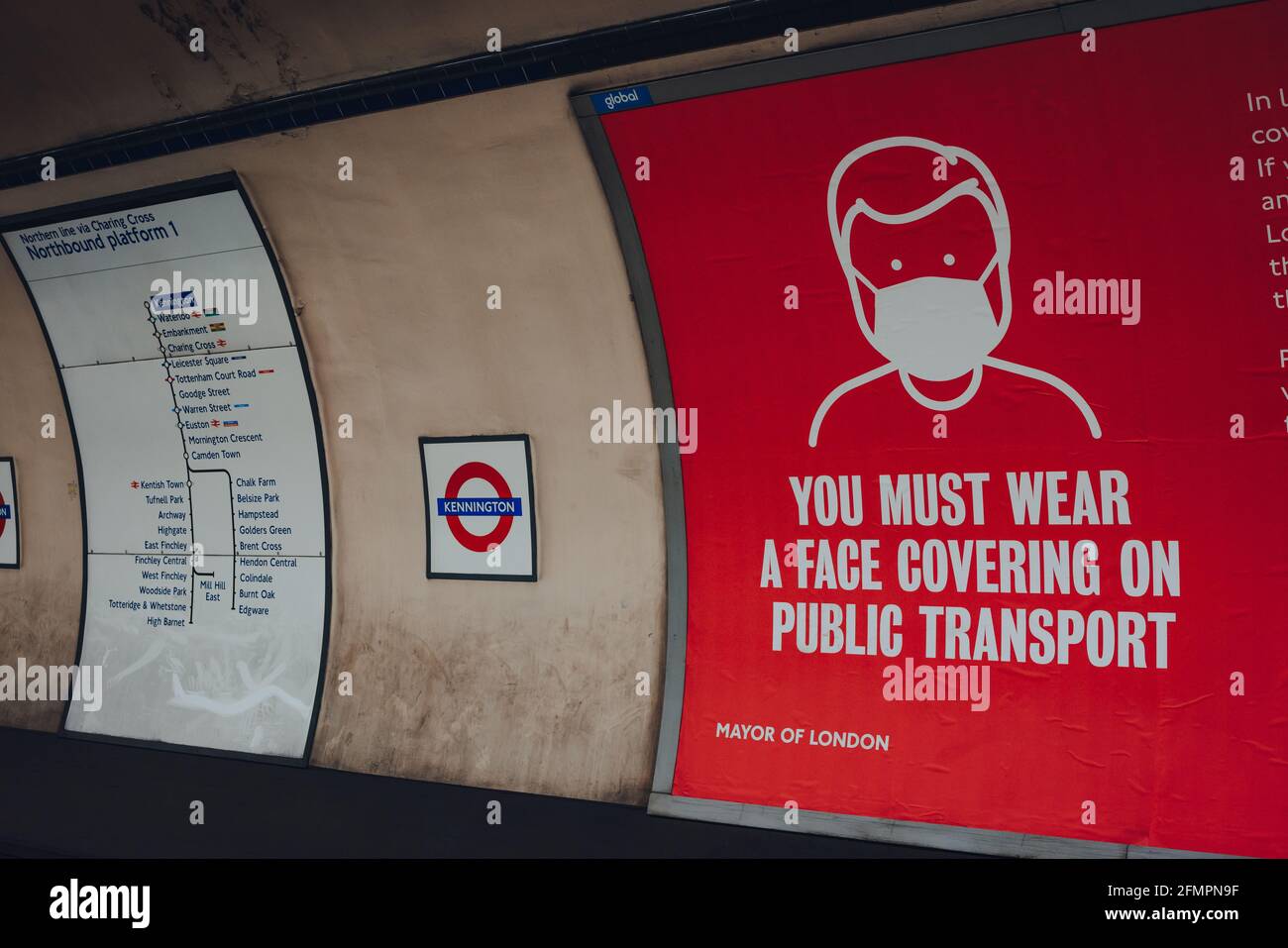 London, UK - May 09, 2021: Face covering requirement sign on the platform of Kennington London Underground Station. The requirements were introduced d Stock Photo