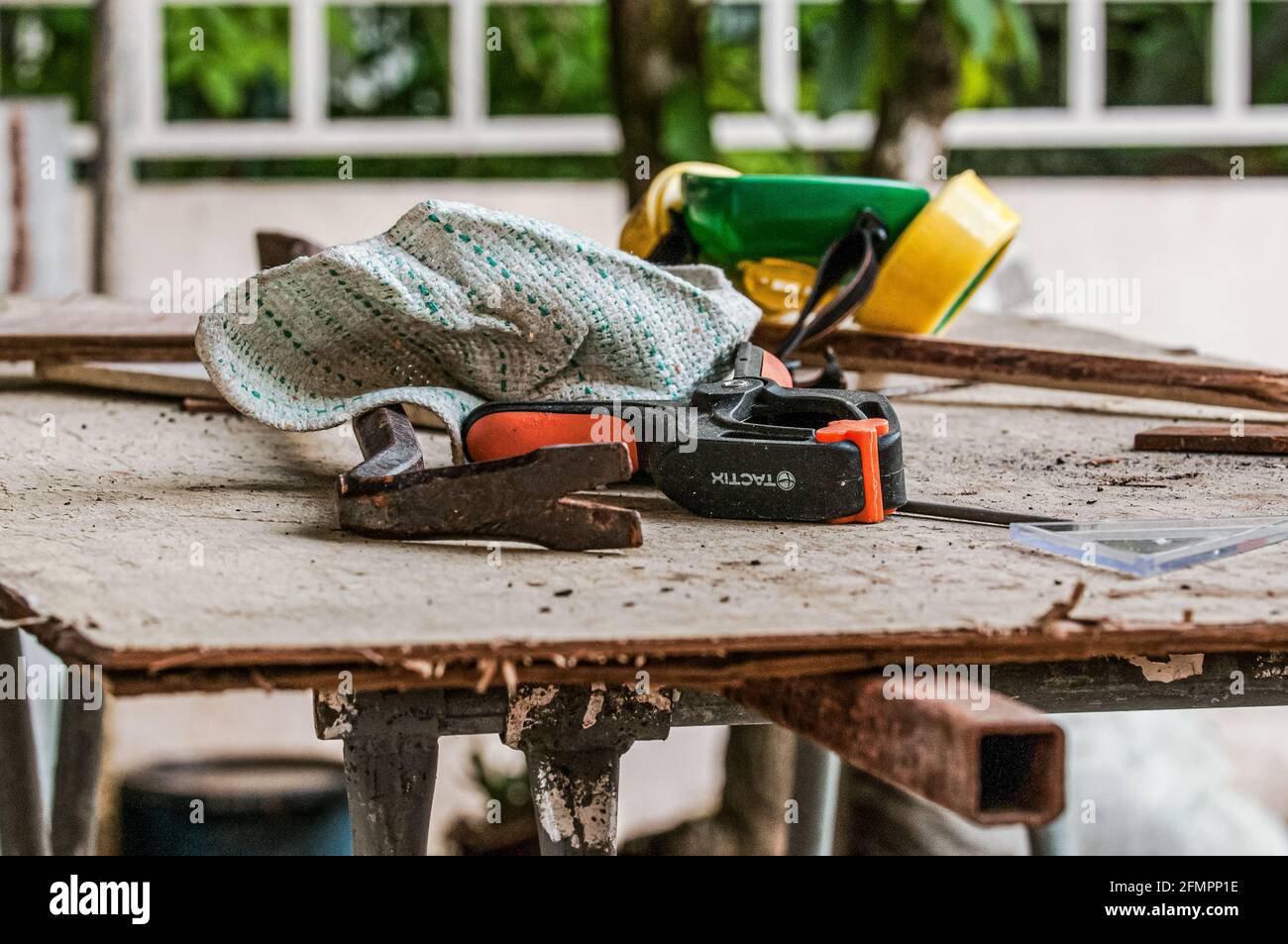 A woodworker's work table covered with equipment, machinery and sawdusts. Stock Photo