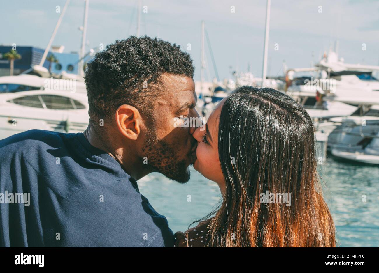 Handsome black man kissing white woman hi-res stock photography and ...