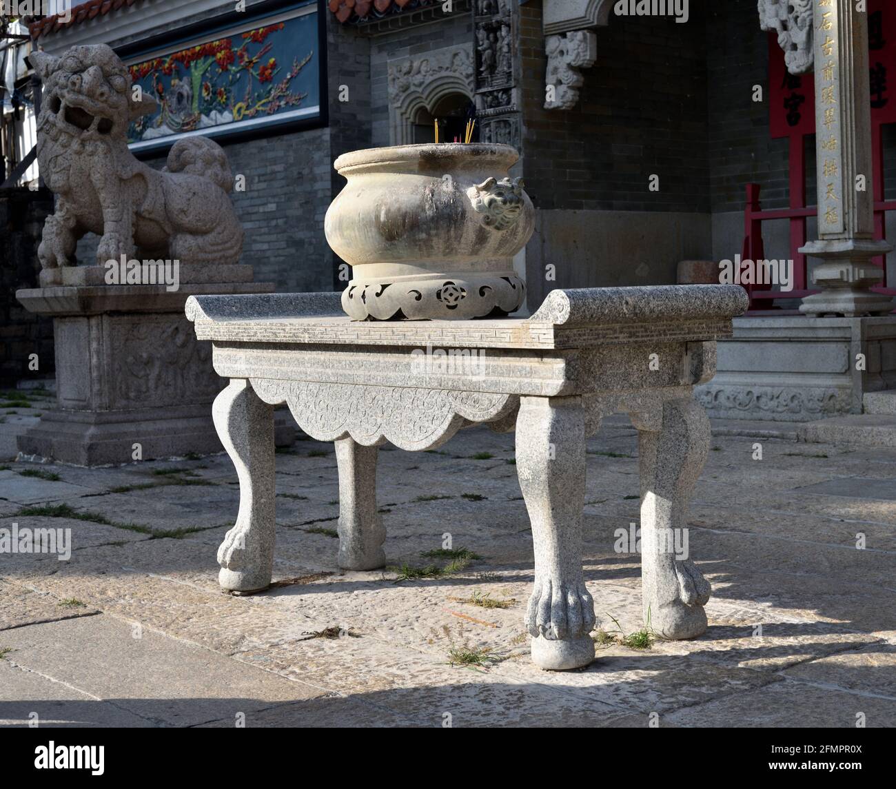 Round Stone incense burner on a curved legs stand in front of Yuk Hui Kung, aka Pak Tai Temple, Cheung Chau, Hong Kong. Stock Photo