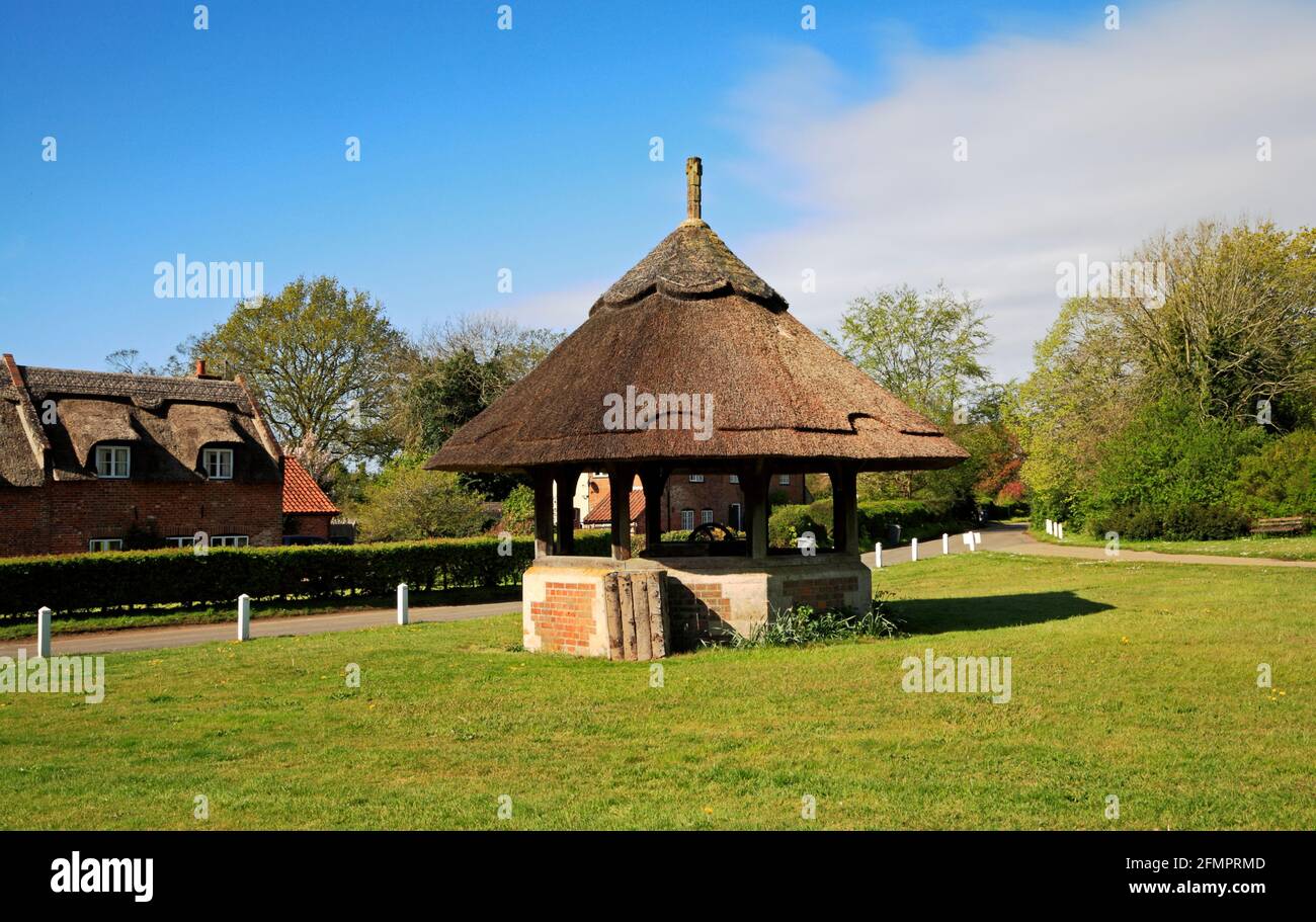 A view of the thatched well house on the picturesque village green in the Norfolk Broads at Woodbastwick, Norfolk, England, United Kingdom. Stock Photo