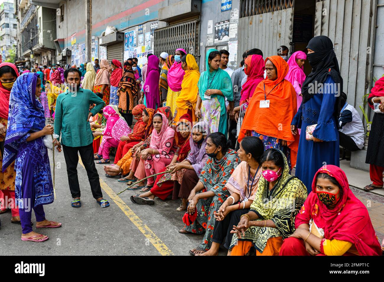 Dhaka, Bangladesh. 11th May, 2021. Garment workers of Binni Garments Ltd block the road at the factory demanding payment of due wages and Eid bonus. (Photo by Zabed Hasnain Chowdhury/SOPA Images/Sipa USA) Credit: Sipa USA/Alamy Live News Stock Photo