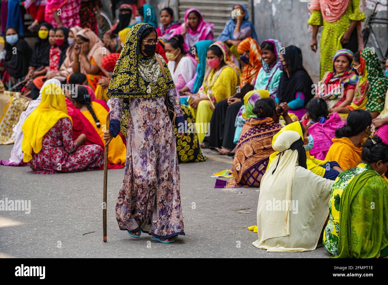 Dhaka, Bangladesh. 11th May, 2021. Garment workers of Binni Garments Ltd block the road at the factory demanding payment of due wages and Eid bonus. (Photo by Zabed Hasnain Chowdhury/SOPA Images/Sipa USA) Credit: Sipa USA/Alamy Live News Stock Photo