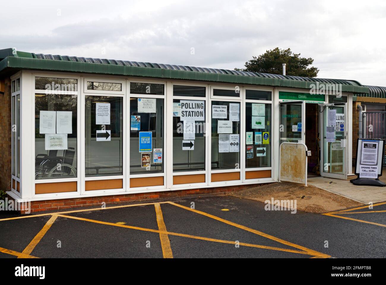 The entrance to a local Community Centre with direction arrows and notice to proceed to the Polling Station. Stock Photo