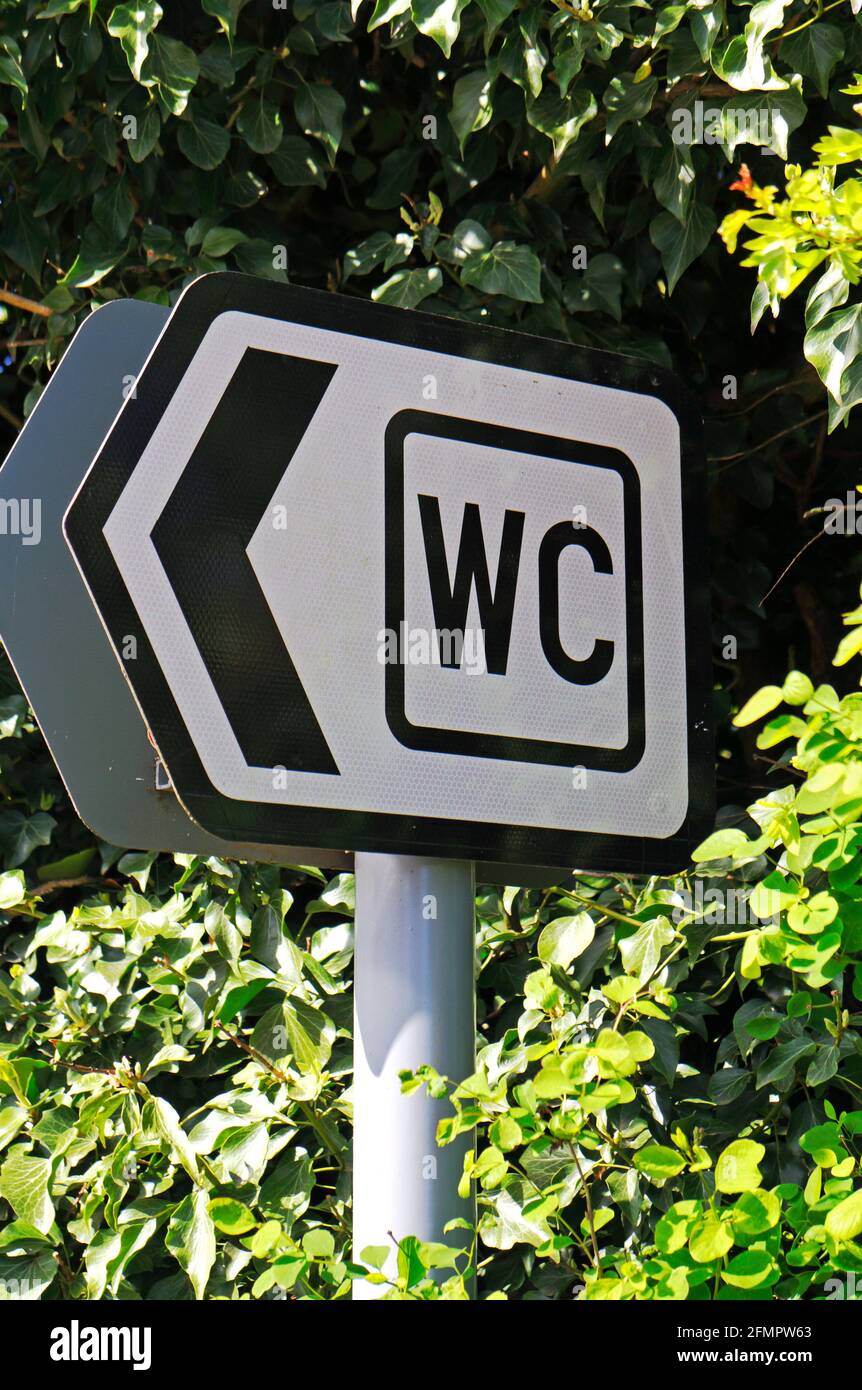 A roadside sign indicating direction to WC and Public Toilets in the Norfolk Broads at Ranworth, Norfolk, England, United Kingdom. Stock Photo
