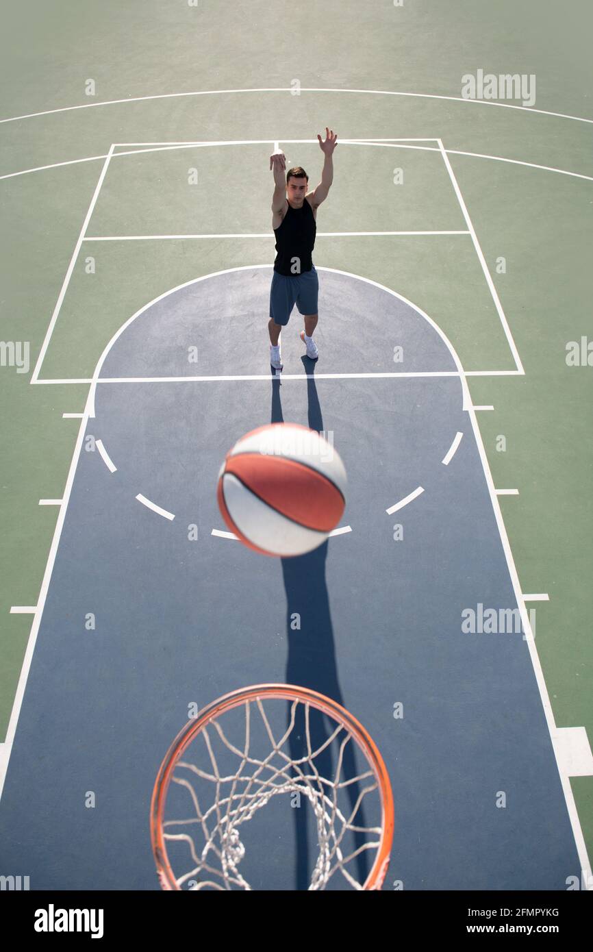 Basketball player, top view. Man playing basketball, above hoop of man