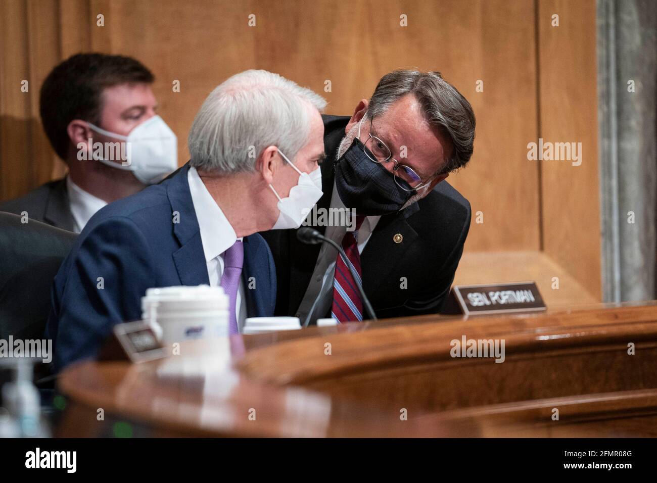 Washington, USA. 11th May, 2021. Senator Rob Portman, a Republican from Ohio and ranking member of the Senate Homeland and Governmental Affairs Committee, left, speaks with Senator Gary Peters, a Democrat from Michigan and chairman of the Senate Homeland and Governmental Affairs Committee, during a committee hearing in Washington, DC, U.S., on Tuesday, May 11, 2021. The hearing is titled 'Prevention, Response, and Recovery: Improving Federal Cybersecurity Post-SolarWinds.' Photo by Sarah Silbiger/Pool/Sipa USA) Credit: Sipa USA/Alamy Live News Stock Photo