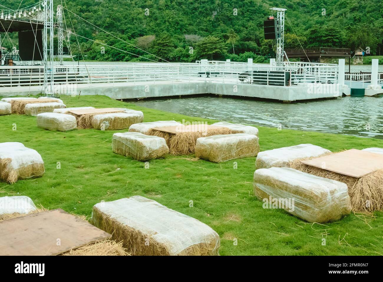 Seats and tables made from straw bales for event and party laid on lawn