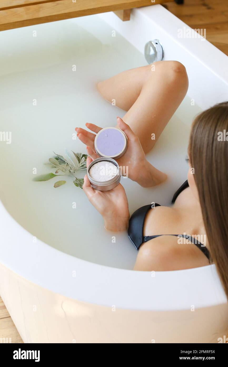 Top view of woman hands with solid soap on white water background ...