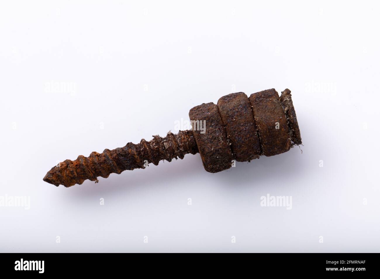 old rusty aged bolt, not usable, rusty item on white background  Stock Photo