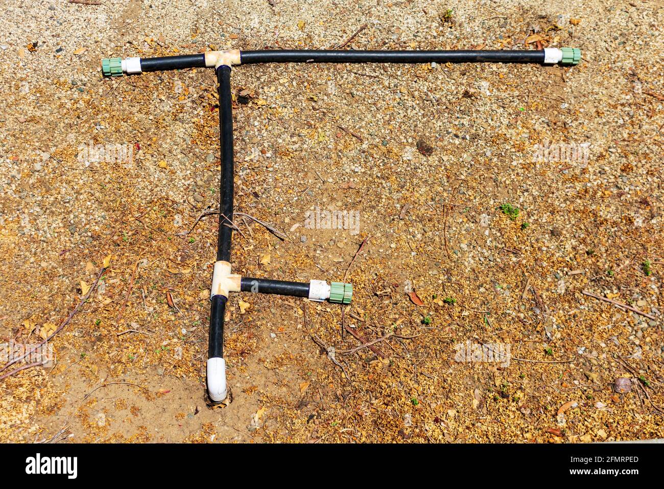 Soaker hose irrigation system typical design layout on dry ground Stock
