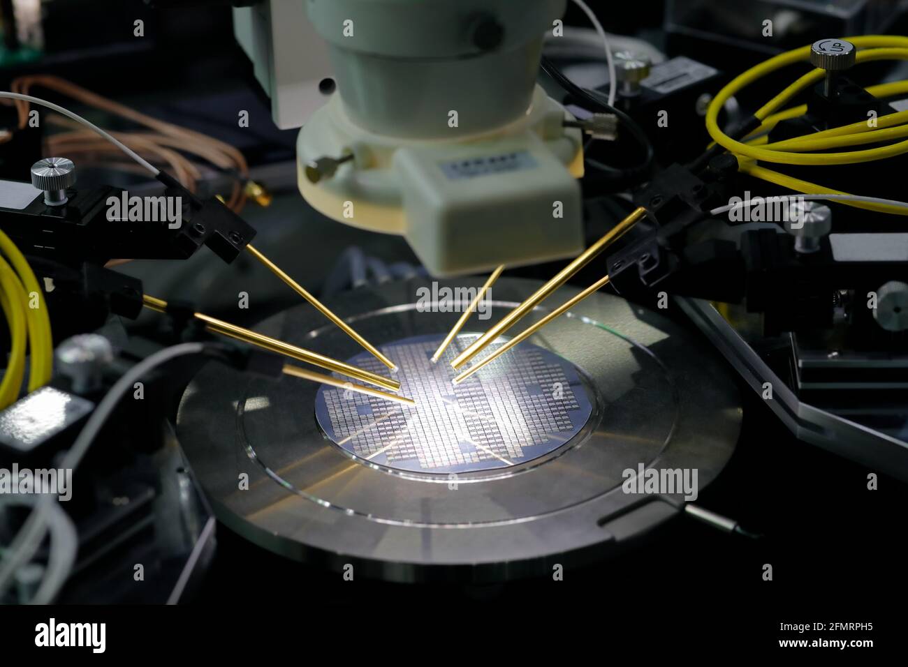 Semiconductor silicon wafer under test on the probe station. Selective focus. Stock Photo