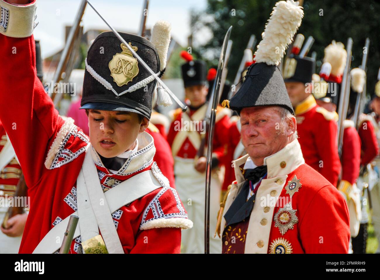 Redcoats of a line regiment: British infantry in the Allied camp exercising the shooting of volleys during the re-enactment of the Battle of Waterloo. Stock Photo