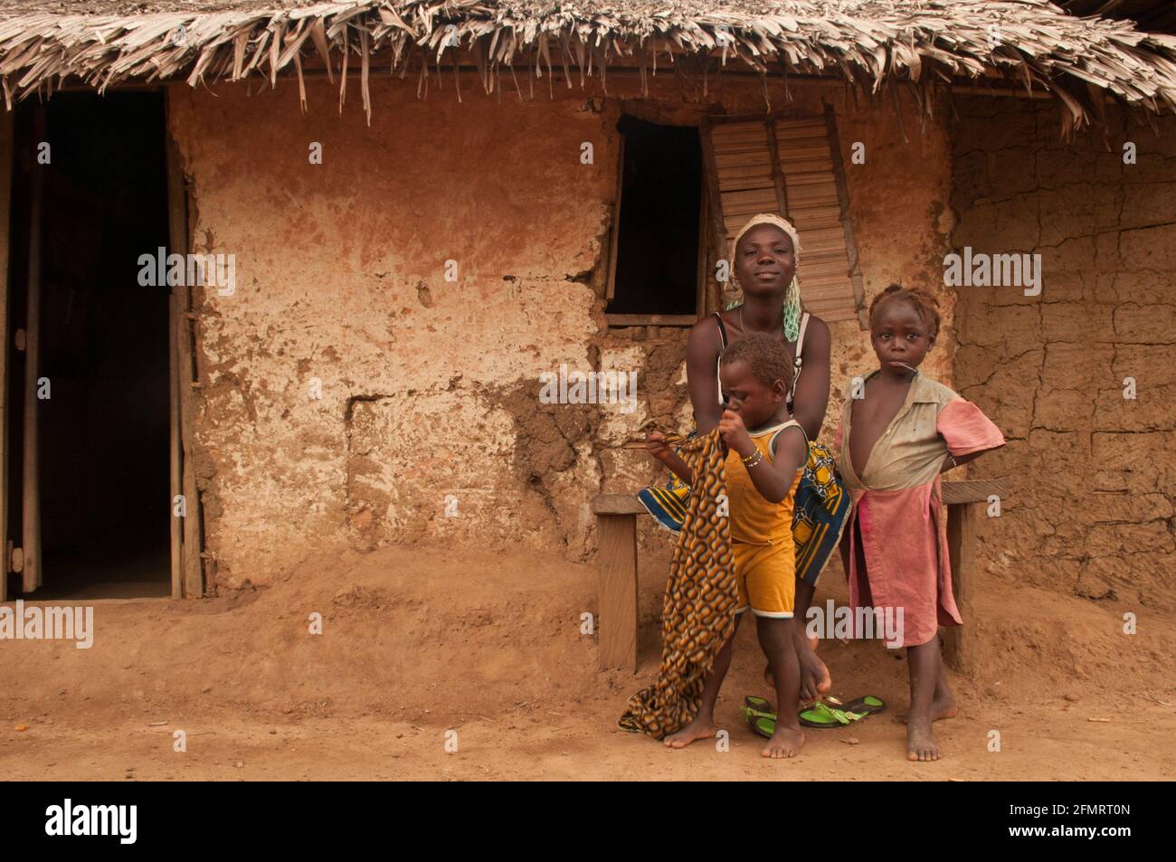 Rural Liberian family sitting in front of their house, Liberia, West