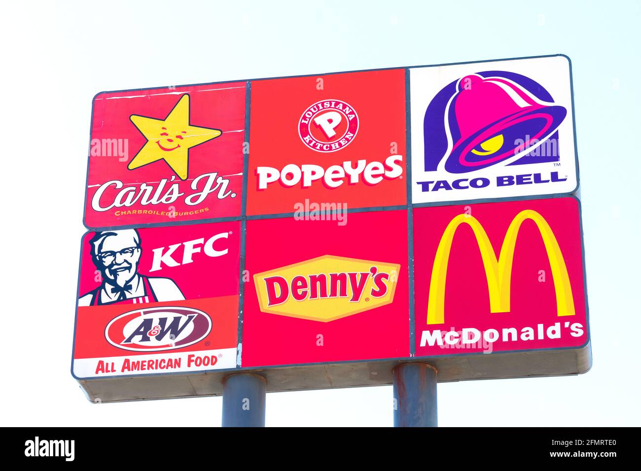 Carl's Jr., Popeyes, Taco Bell, KFC, Denny s and McDonald's fast food restaurants logos on road sign. Interstate highway advertising sign. - Stockton, Stock Photo