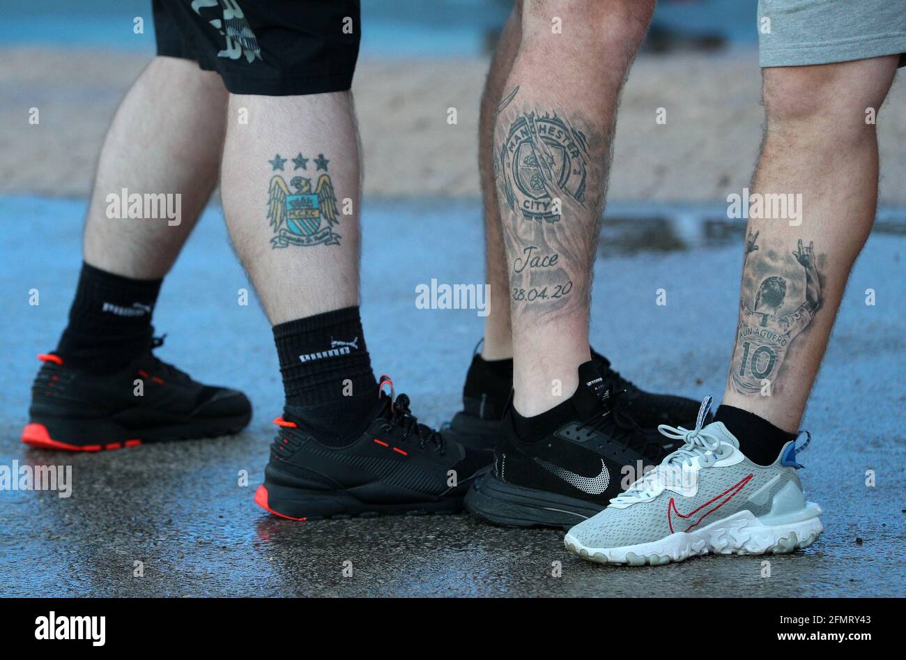 Manchester City fans show leg tattoos as they celebrate at the Etihad  Stadium, after Manchester City were crowned Premier League champions  following Manchester United's home defeat to Leicester. Picture date:  Tuesday May