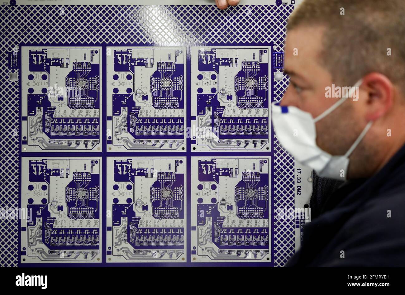 An employee of Atlantec Technologies works on printed circuit boards at the  company's factory in Malville near Nantes, France, May 11 2021.  REUTERS/Stephane Mahe Stock Photo - Alamy