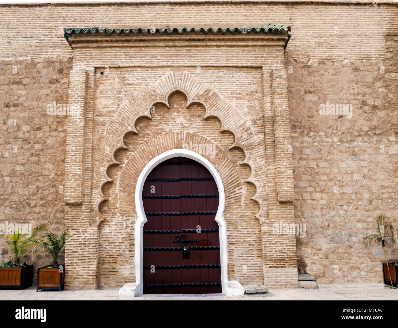 White surround to a massive wooden door on this entrance to the Koutoubia Mosque Marrakesh Stock Photo