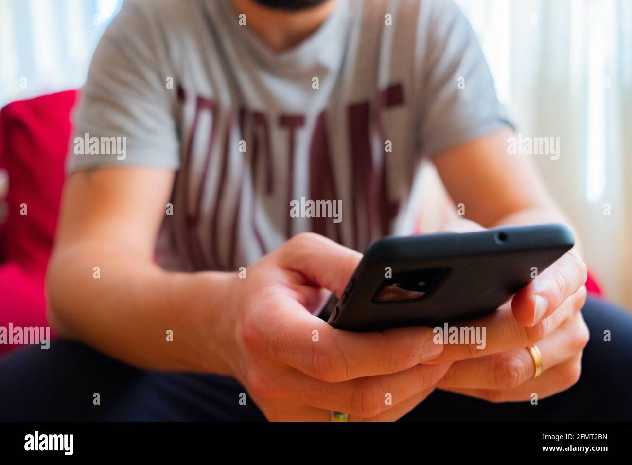 Male using a black smartphone Stock Photo