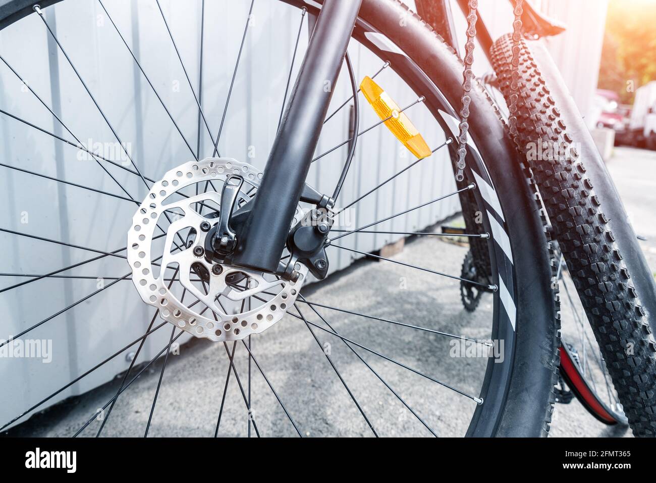 Closeup detail disassembled black carbon fiber bicycle with removed wheel and tyre after