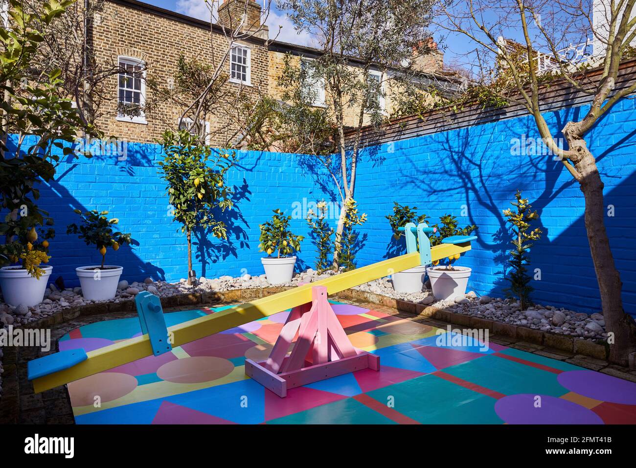 Backyard of store. Mira Mikati Happy House, London, United Kingdom. Architect: Yinka Ilori, 2020. Stock Photo