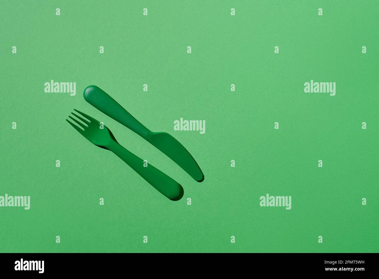 Plastic fork and knife on match background Stock Photo
