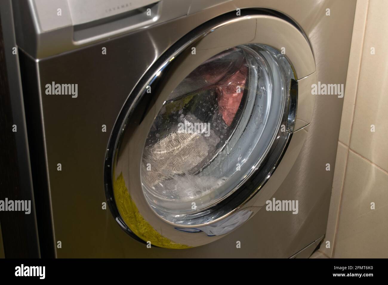 Aeg inox front clothes washing machine on job, how to do Laundry Stock  Photo - Alamy