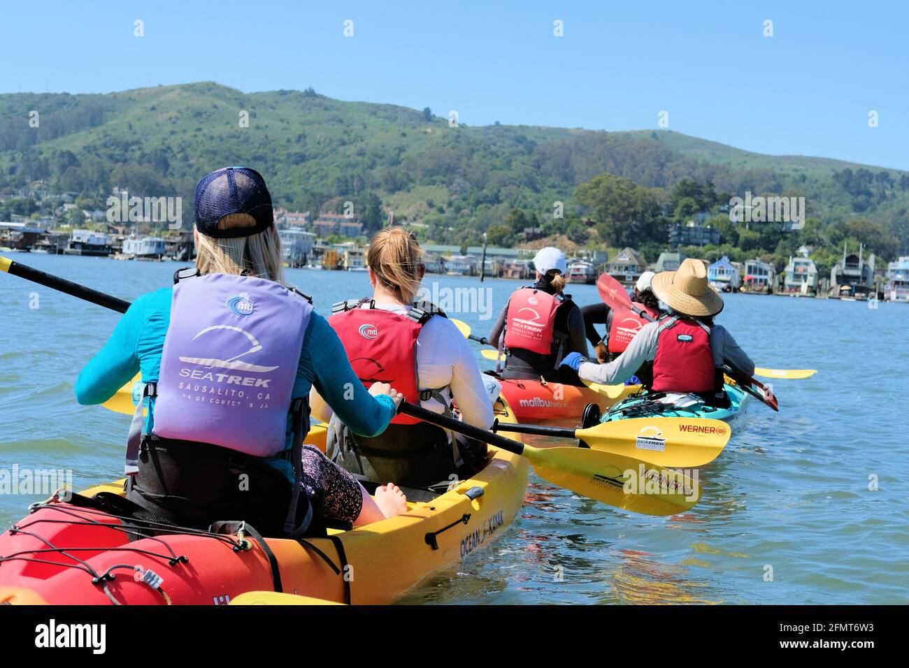 A group of five paddling on kayaks on Richardson Bay in Sausalito, Marin County, California on a sunny day; San Francisco Bay outdoor recreation. Stock Photo