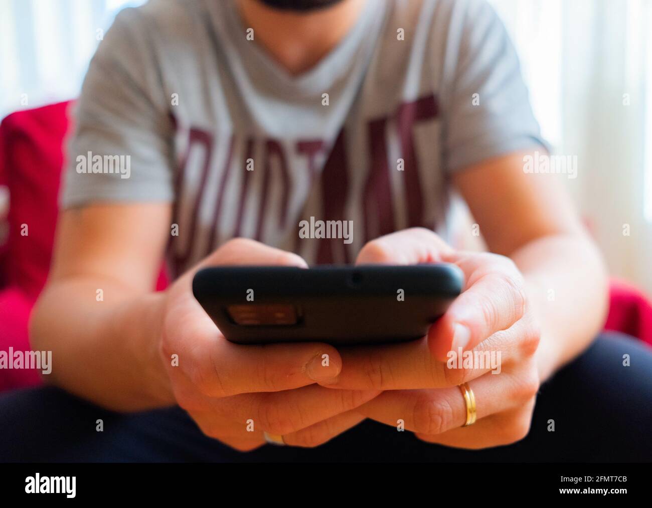 Male using a black smartphone Stock Photo
