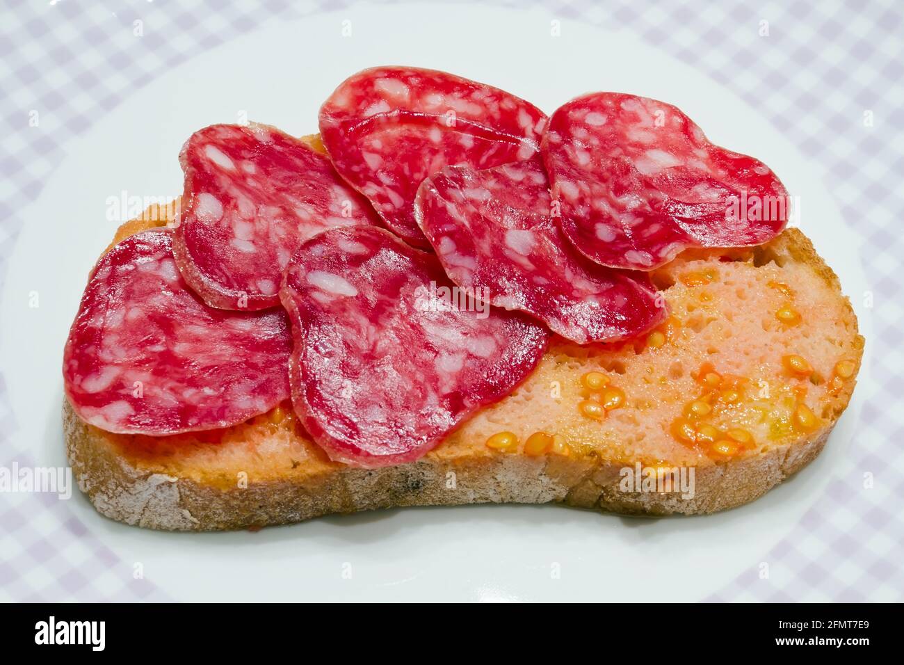 Catalanstyle tomato rubbed on a slice of bread with oil and salt point