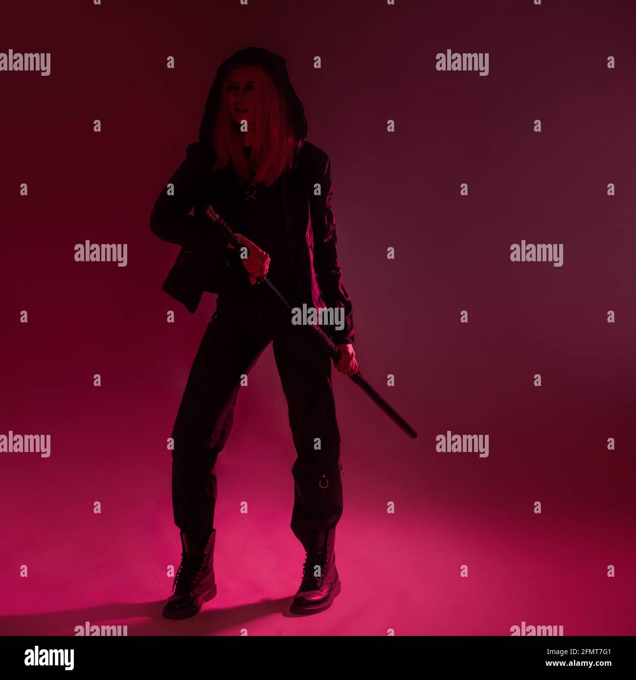 https://c8.alamy.com/comp/2FMT7G1/techno-cyber-punk-style-futuristic-ninja-young-woman-with-pink-hair-in-black-clothes-with-a-katana-studio-photo-magenta-light-2FMT7G1.jpg