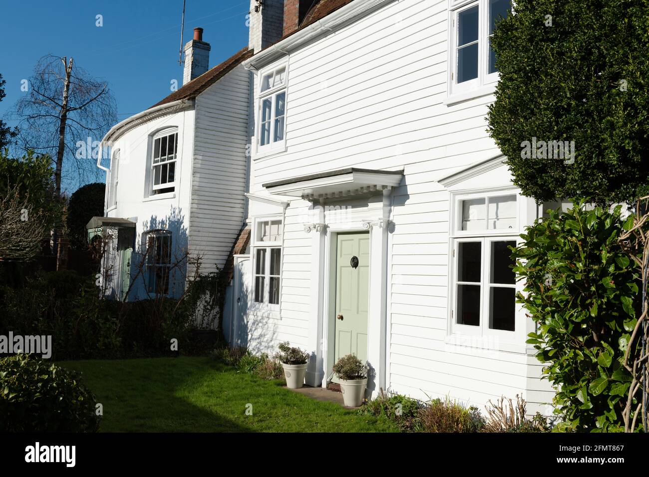 Two whiewashed houses, one weatherboarded and the other with a convex frontage, near to the centre of the market town of Horsham in West Sussex, Uk Stock Photo