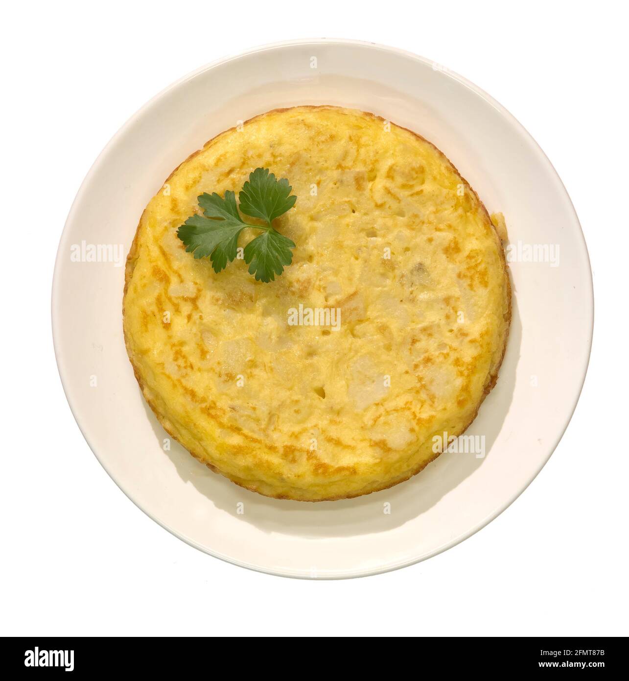 Spanish omelette with potatoes, parsley leaf gift auction, white background Stock Photo