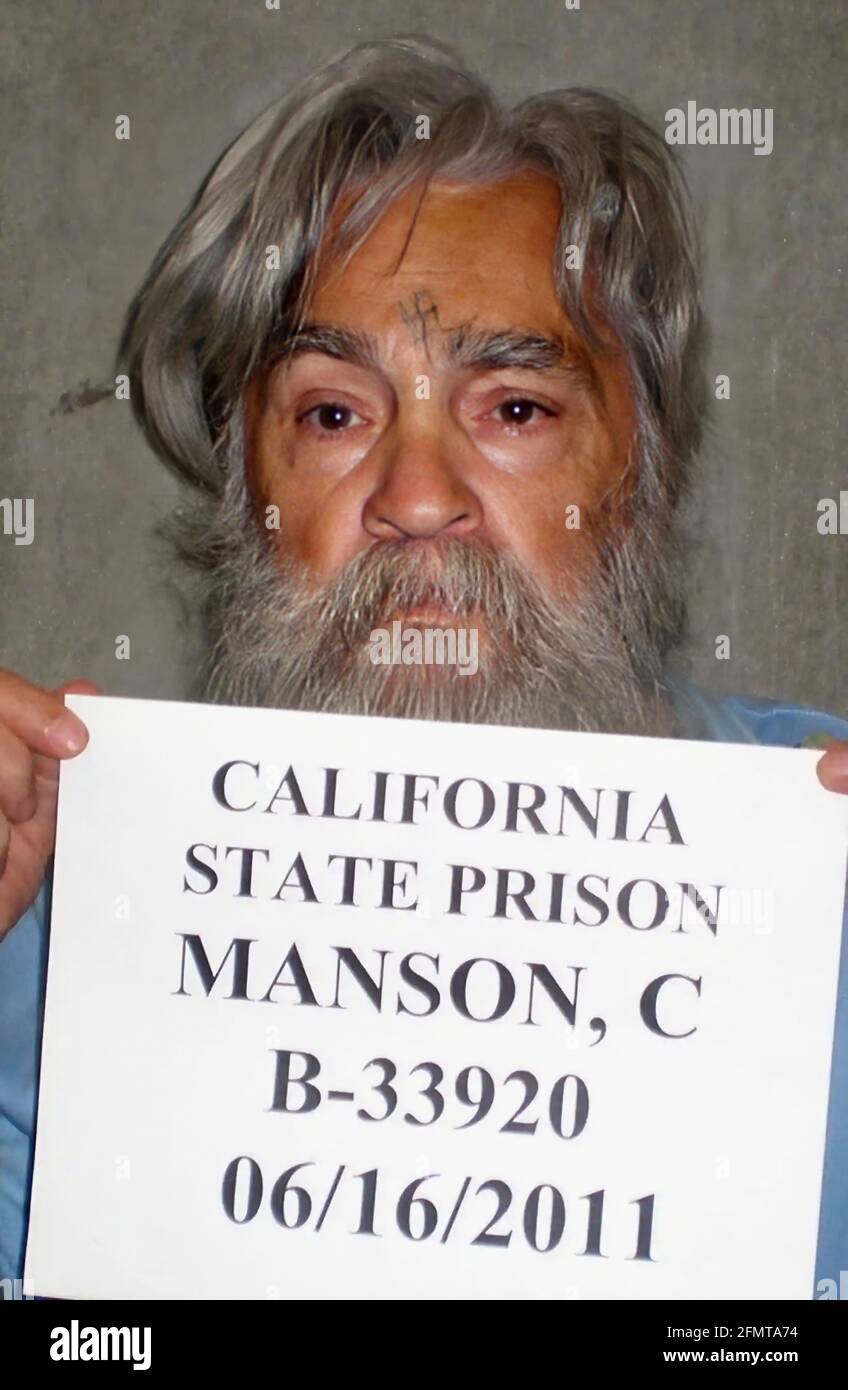 2011 , 16 june , USA : Mugshot of famous american satanist cult leader and criminal killer CHARLES MANSON SATANA ( 1934 - 2017 ). In mid-1967, he formed what became known as the ' Manson Family ', a quasi-commune based in California. His followers committed a series of nine murders at four locations in July and August 1969 . In 1971, he was convicted of first-degree murder and conspiracy to commit murder for the deaths of seven people, including the film actress Sharon Tate . Unknown photographer of California Prison . - MUGSHOT - Mug Shot - Mug-Shot - SVASTICA nazista - nazi nazist SVASTIKA - Stock Photo
