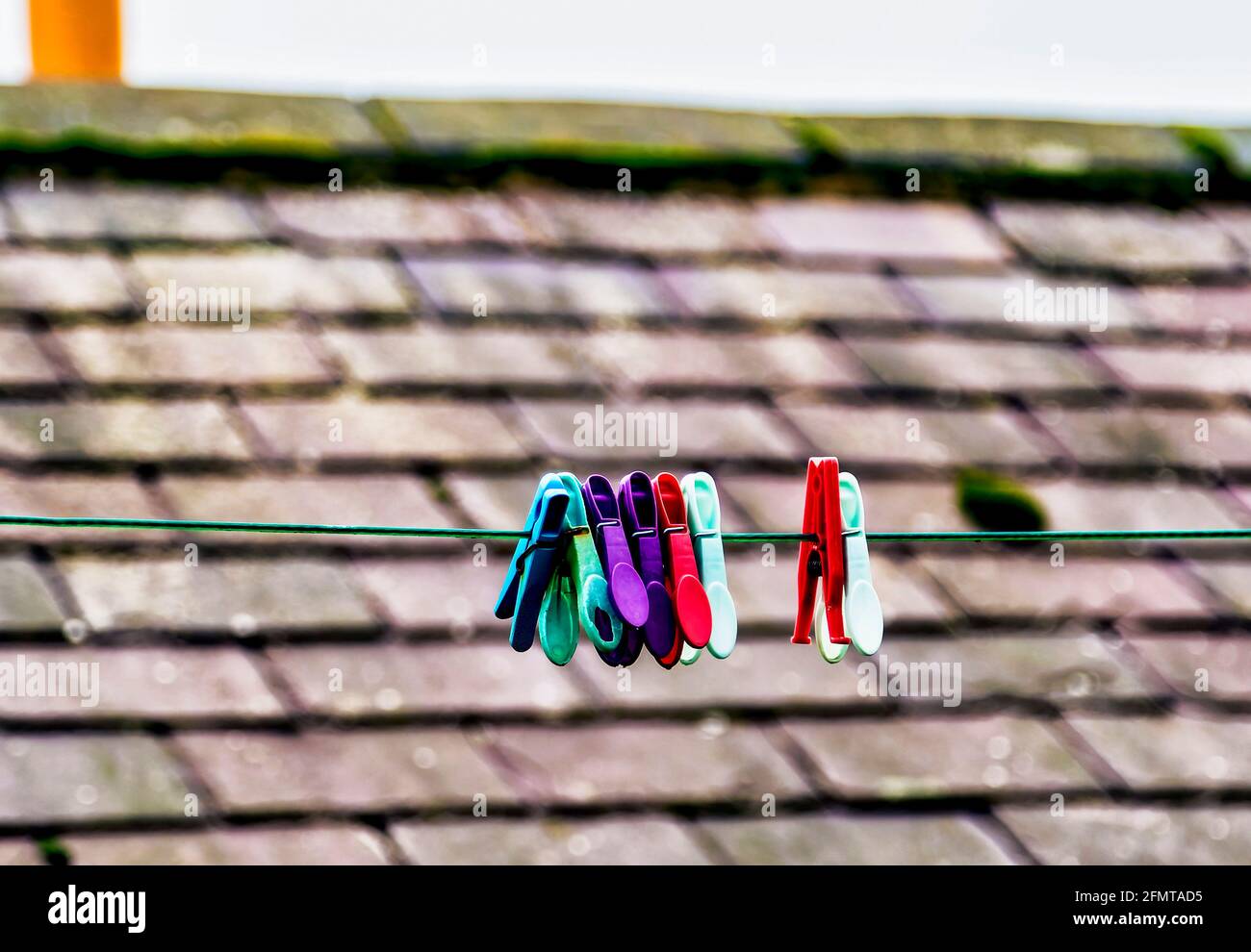 Plastic pegs clipped to a clothes line in an English village Stock Photo