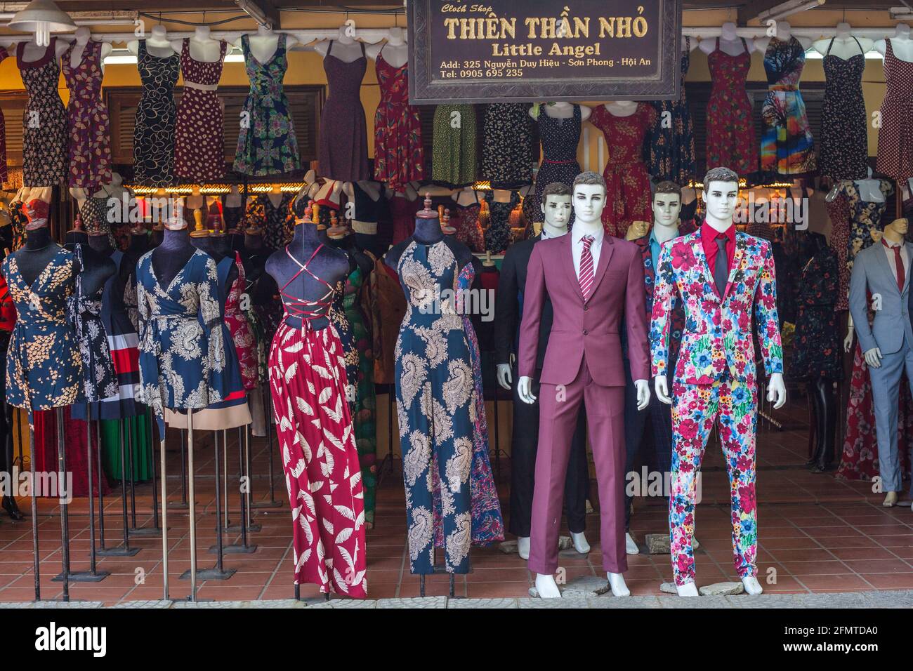 Snazzy designs on shop mannequins outside textile trader in Hoi An, Vietnam Stock Photo