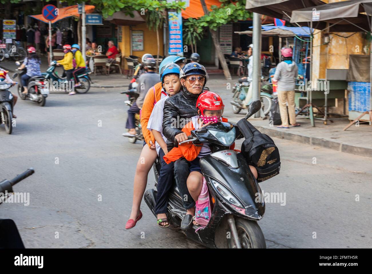 Vietnamese family of four crammed on scooter, Hoi An, Vietnam Stock Photo