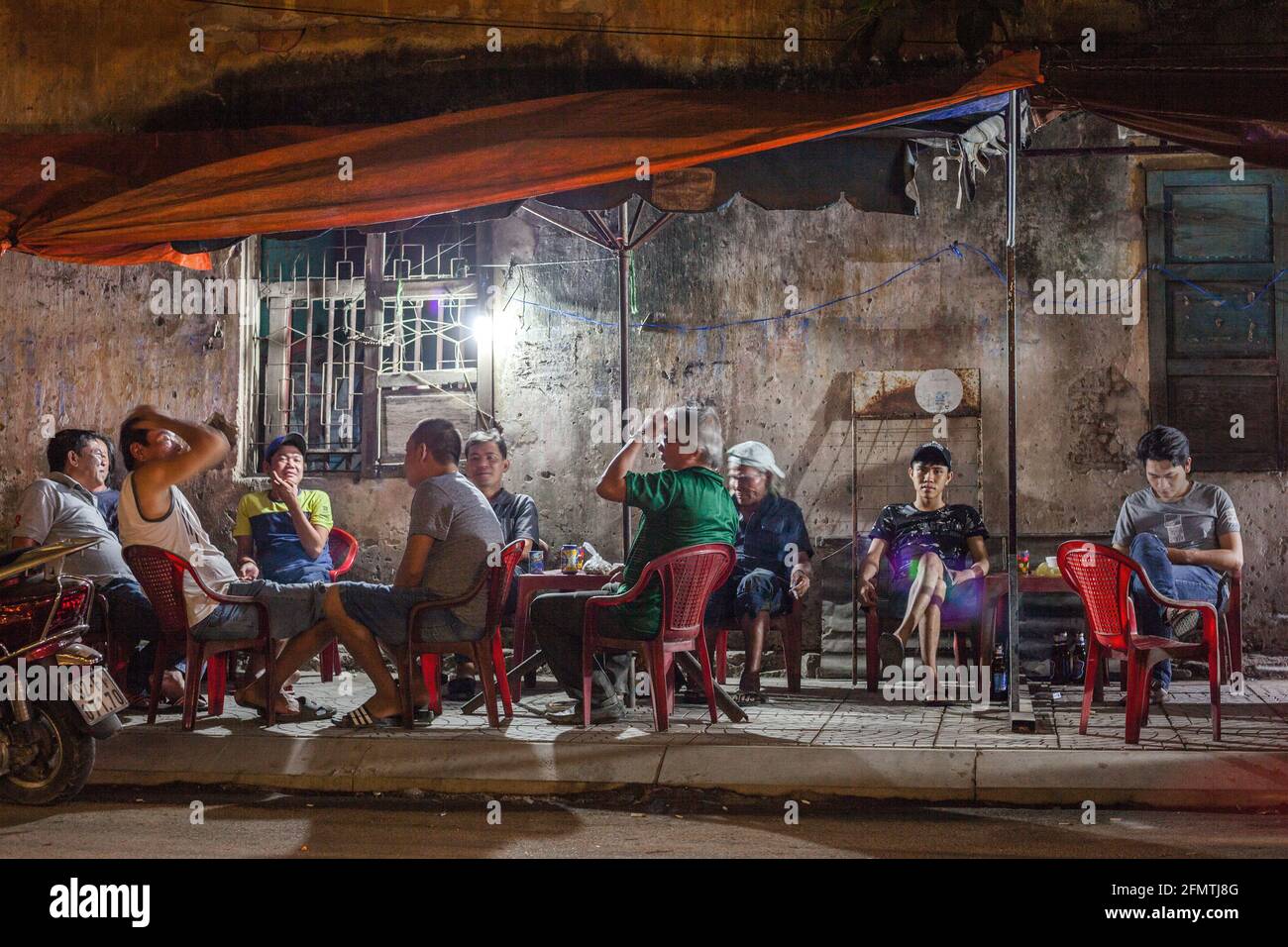Vietnamese males seated at ambient roadside cafe after dusk, Hoi An, Vietnam Stock Photo Alamy