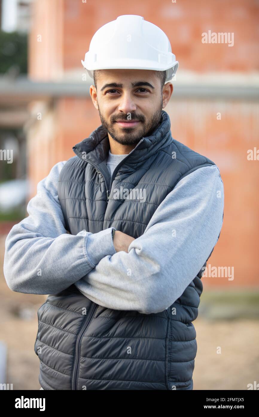 portrait of smiling young builder posing Stock Photo