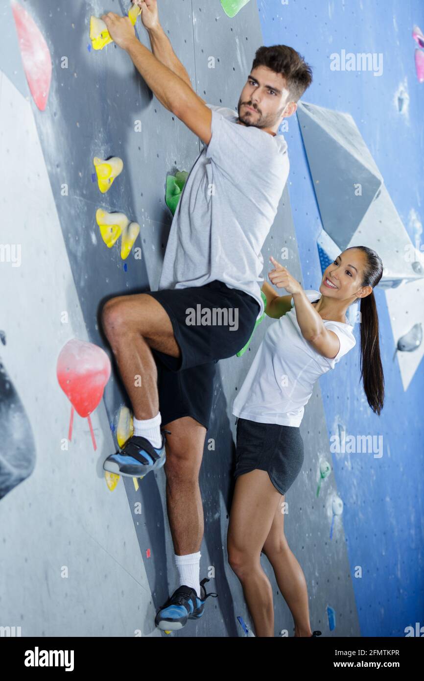 female wall climbing instructor giving instructions Stock Photo - Alamy