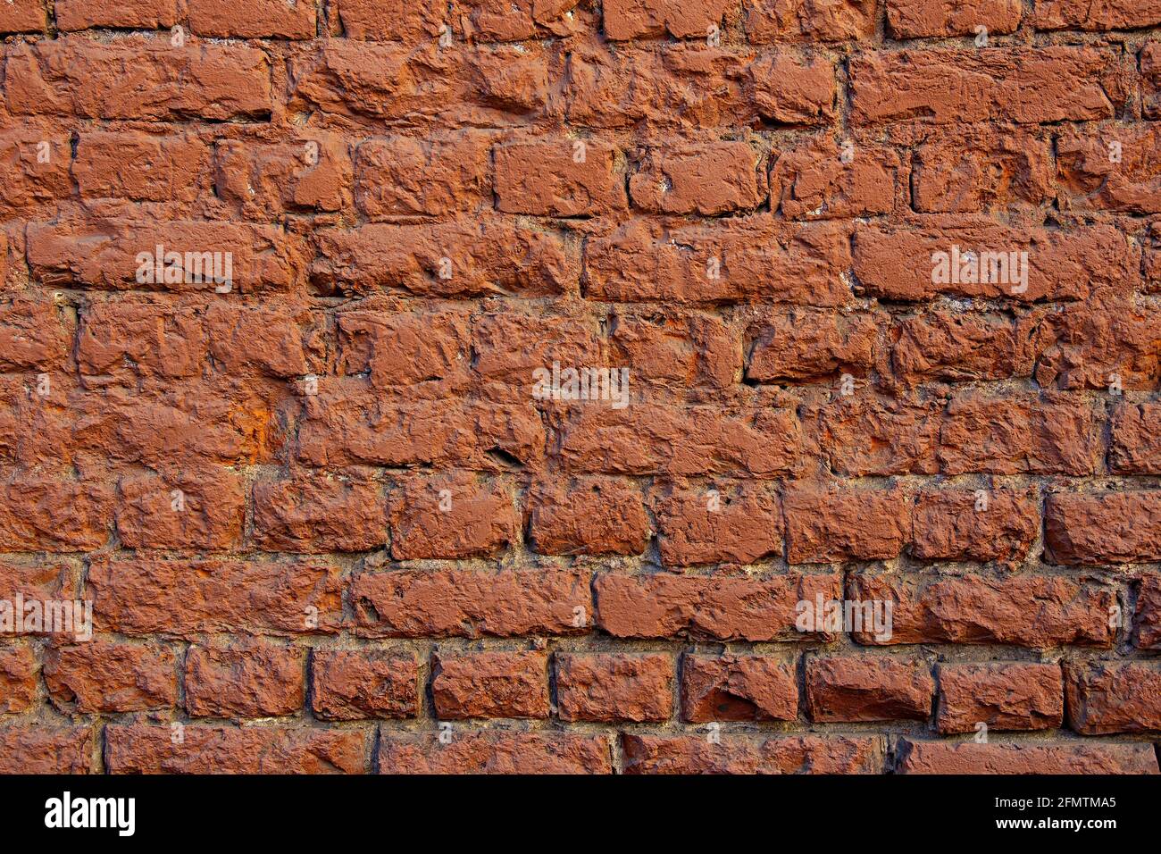 Old weather-beaten grunge red brick wall background Stock Photo