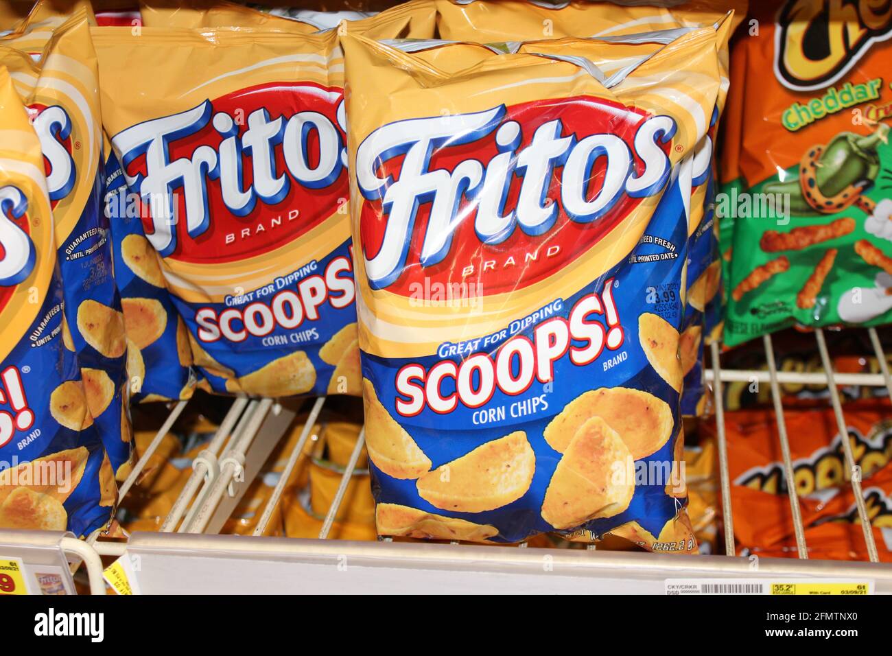 Fritos Scoops shot closeup on a metal shelf that's bright and colorful